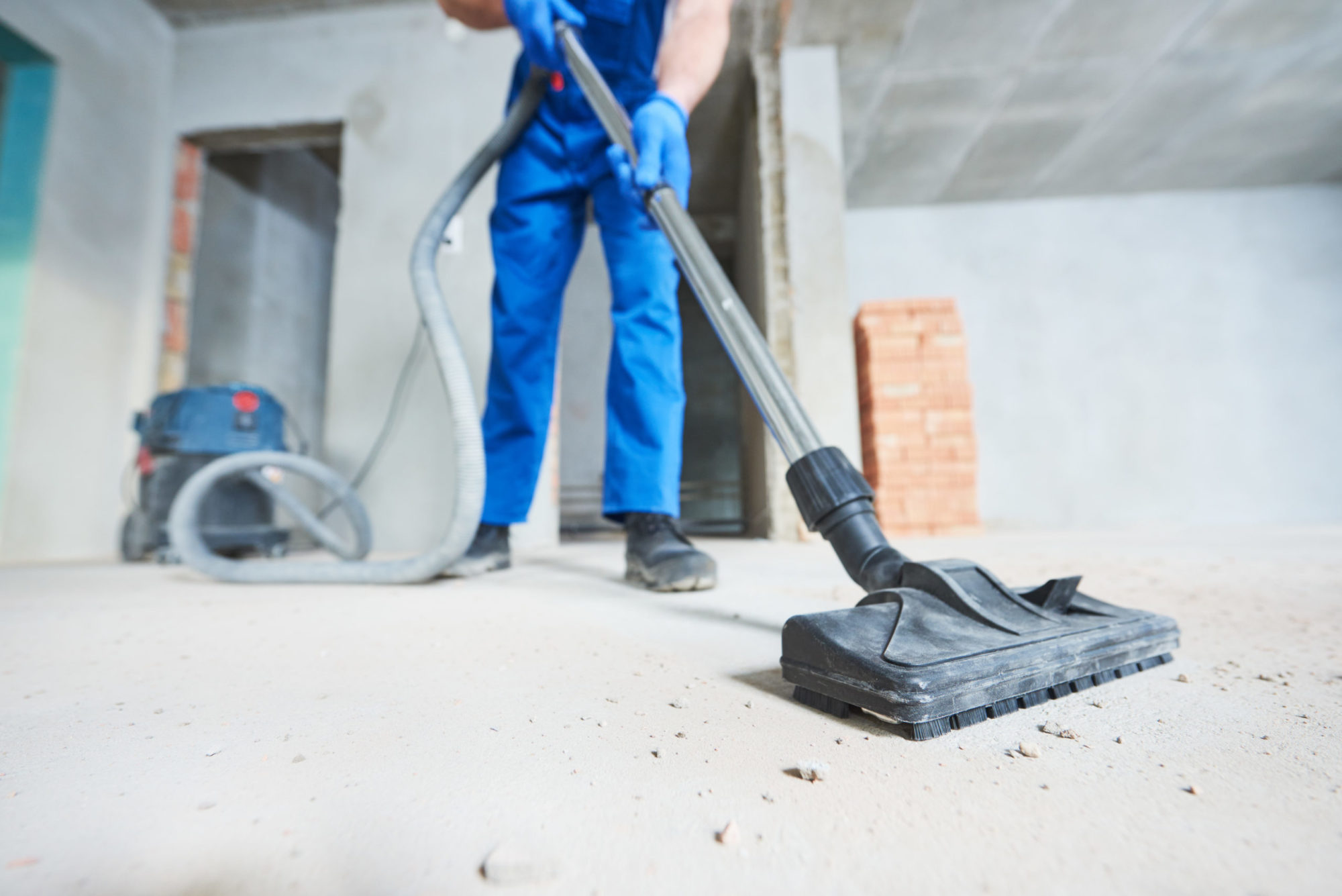 young woman cleaning and removing construction dust with